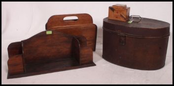 A Victorian tin hat box of oval form with hinged top and clasp. Carry handle to the centre.