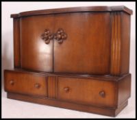An unusual art deco oak buffet / sideboard having two drawers below two doors to reveal shelved