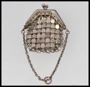 A silver mesh linked penny purse. Unmarked, tests as silver, clasp handle atop with chain.