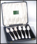 A cased set of six silver plated grapefruit spoons with a grapefruit knife having a hallmarked