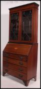 An Edwardian mahogany inlaid bureau bookcase raised on bracket feet with chest under bureau.