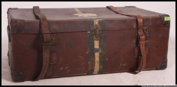An early 20th century Harrods canvas, leather and wooden bound steamer trunk.