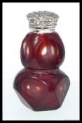 A Victorian style ruby glass and 925 sterling silver topped perfume bottle.