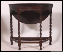 An excellent quality 1920's oak drop leaf circular barleytwist side / occasional table.