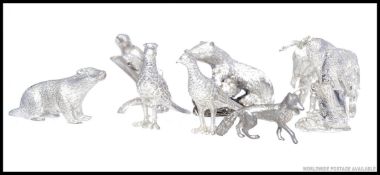A collection of white metal animal ornaments of decorative form being well crafted.