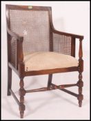 An Edwardian mahogany and Bergere cane inlaid library chair.