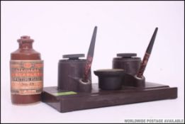 A fabulous 1930's Art Deco bakelite desk tidy inkwell with twin pots and pens.