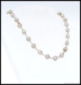 A decorative silver metal ( tests as silver ) fret work ball finial necklace 45cm in length,