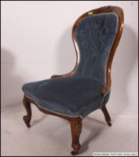 A late 19th Victorian mahogany spoon back Nursing chair,