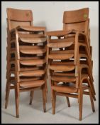 A stack of 12 vintage ply wood Industrial wooden school chairs.
