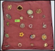 A collection of 20 costume jewellery brooches to include enamel, stone set,