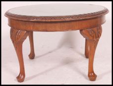A good quality mid 20th century walnut quarter vaneered occasional / coffee table raised on