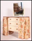 A 1940's painted retro kidney dresser with drawers and sliding curtain covers.