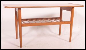 A mid century teak vintage / retro surf board style coffee table complete with magazine rack