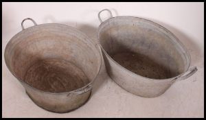 Two 20th century vintage Industrial galvanised metal - tin baths,