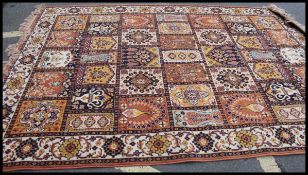 A 20th century hanging wall tapestry together with a Chinese floor rug with tassled ends.