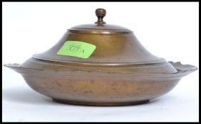 A bronzed Islamic food dish and lid. The base with scalloped edge having finial atop of lid.
