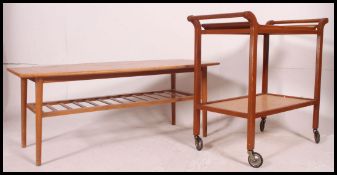 A retro vintage 1970's teak table together with a retro butlers serving trolley.