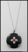 A silver, black glass and bloodstone set ladies pendant and necklace.