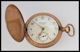 An early 20th century yellow metal cased AM Watch Co, Waltham Mass full hunter pocket watch.