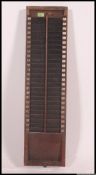 A vintage wall mounted wooden clocking in and out card holder,