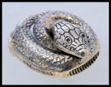 A white metal (marked ' sterling ' for silver ) antique style vesta in the form of a coiled snake.