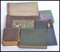 A collection of photograph albums and postcard albums mainly empty but some with cards in.