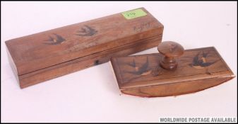 A 20th century olive wood pen box with inlaid swallow decoration together with a matching blotter.