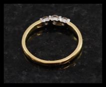 An 18ct gold ladies 3 stone diamond ring. The round cut 3 stones approx 25pnts. Total weight 2.
