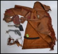 A mid century leather childs Cowboy dressing up costume, complete with sheriff badge,