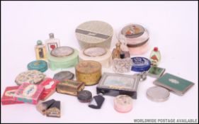 A collection of vintage ladies vanity items to include powder puffs (one Tweed ) rouge, soaps.
