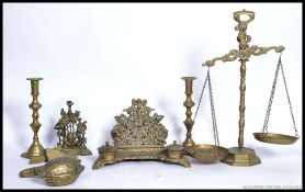 A collection of brasswares to include a Victorian desk tidy of rococo form, large twin scales,