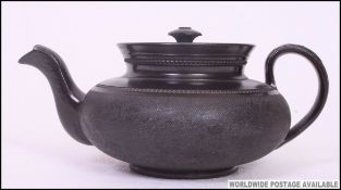 An early 19th century black basalt ware teapot by Cyples.