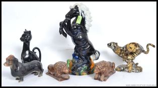A collection of ceramics to include a ceramic study of a horse, Cheetah, cat,
