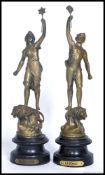 A pair of spelter figures having a gilt finish raised on socle bases,