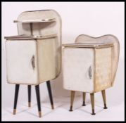 A near pair of white vinyl mid century bedside cabinets, having raised shelf,