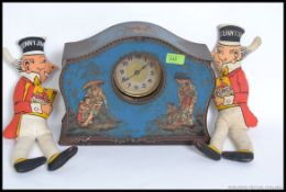 An unusual mid century V Victory chocolate tin with original inset clock together with a pair of