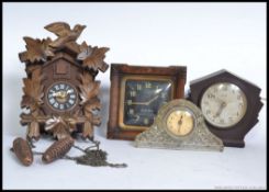 A collection of clocks to include a cuckoo clock, Bakelite Ferranti,