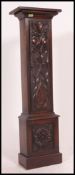 A carved oak clock pedestal stand cupboard.