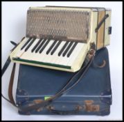 A cased vintage Hohner Alpina Accordion complete with the original case