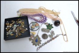 A collection of costume jewellery to include brooches, bangles, earnings, cuff links, necklaces,