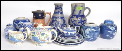 A collection of blue and white ceramics to include willow pattern teapot,