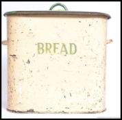 An early 20th century vintage two tone enamel bread bin with notation to the centre having cream