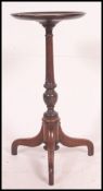 A 19th century mahogany tripod wine table.