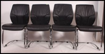 A set of 4 black leather and chrome cantilever dining chairs.