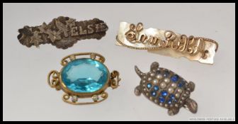 A collection of 4 brooches to include a gold and mother of pearl forget me not brooch,