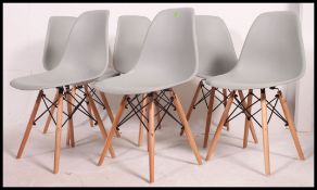 A set of 6  Eames style DSW dining chairs being raised on atomic style legs with upper peripheral