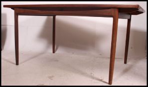 A stunning Kofod Larson for G-Plan teak twin leaf extending dining table.