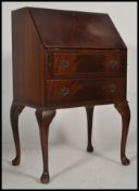 A 1950's Queen Anne revival mahogany ladies writing bureau desk.