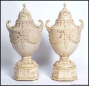 A pair of Staffordshire stoneware Weedon urns with
swag detailing H 45cm W 22cm